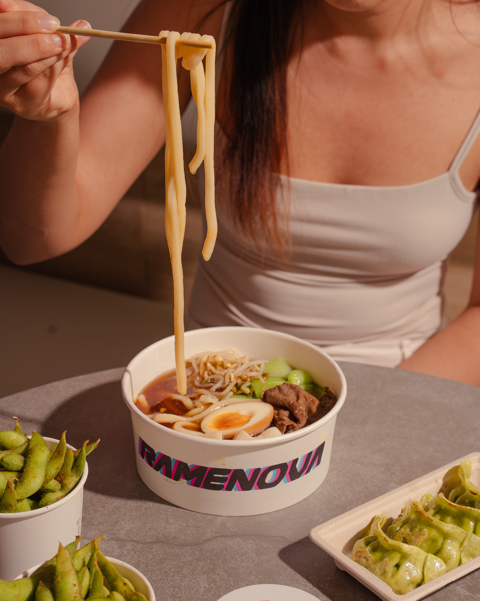 Udon noodles lifted from a Ramenova beef ramen bowl
