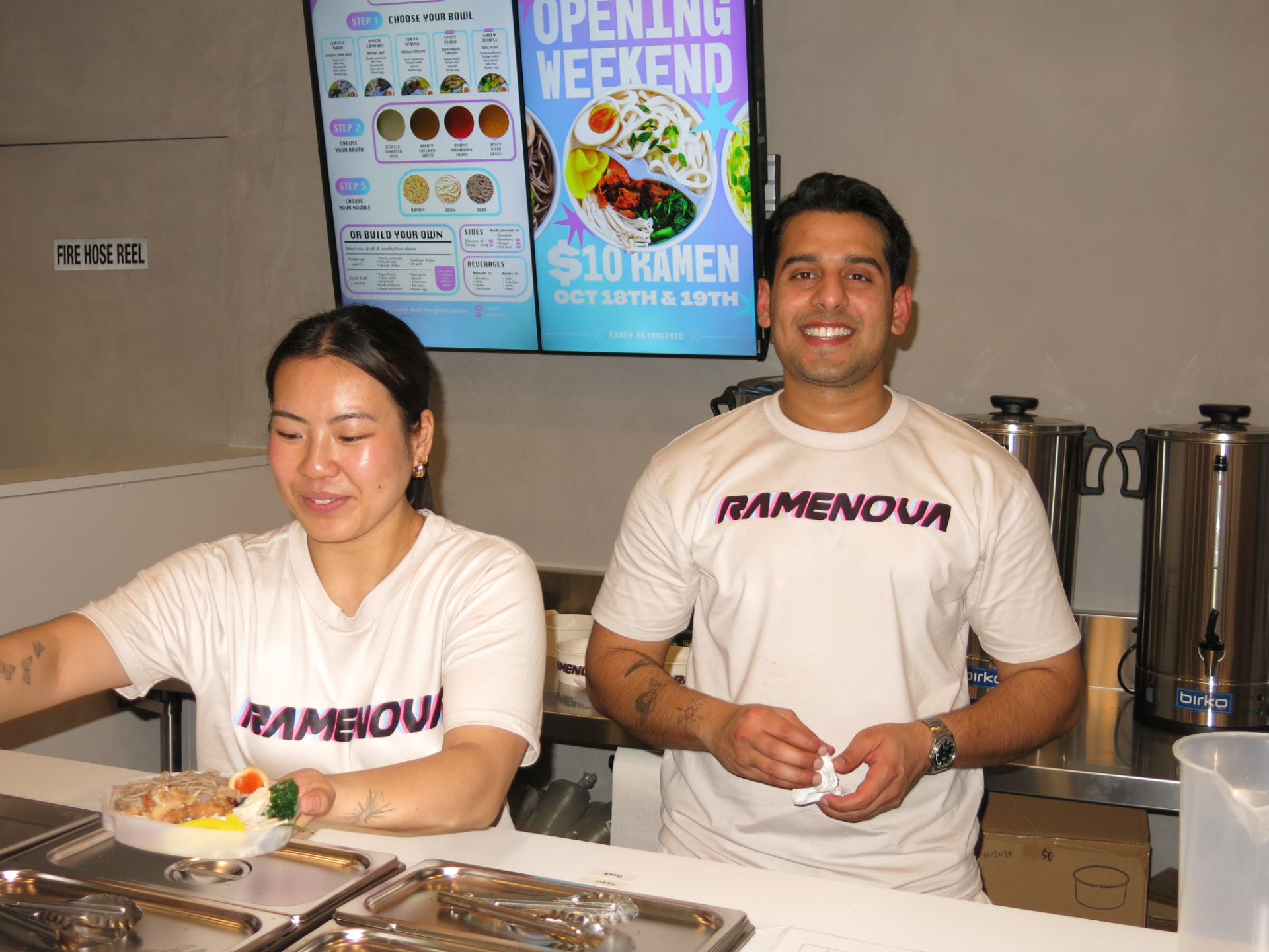 Sophia and Tanmay serving ramen behind the counter at Ramenova South Yarra
